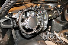 インテリアはカーボンやアルミ、本革が贅沢に使われており、デザインのモチーフはスイス製の機械式時計なのだとか。エンジンの始動はインパネ下部のシリンダーに、ウアイラのシルエットをかたどったキーを差し込んで行う。キーを捻るとアルミ製のメーターパネルの針が鮮やかな照明とともにクンと上がり、ドライバーの気分を高揚させる。