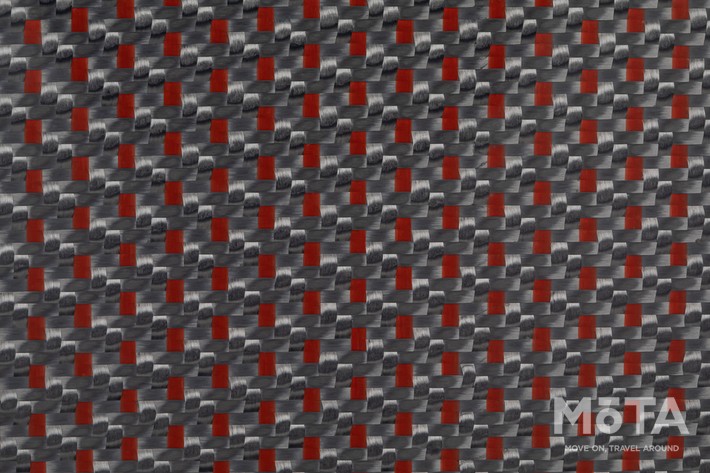 カーボン繊維にレッドポリエステルを編み込んだ素材