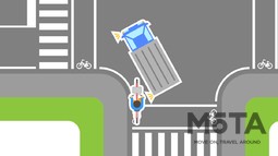 自転車が左折するトラックに巻き込まれる